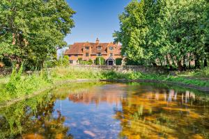 The Pekes Manor Estate - The Manor House from beyond the lake.